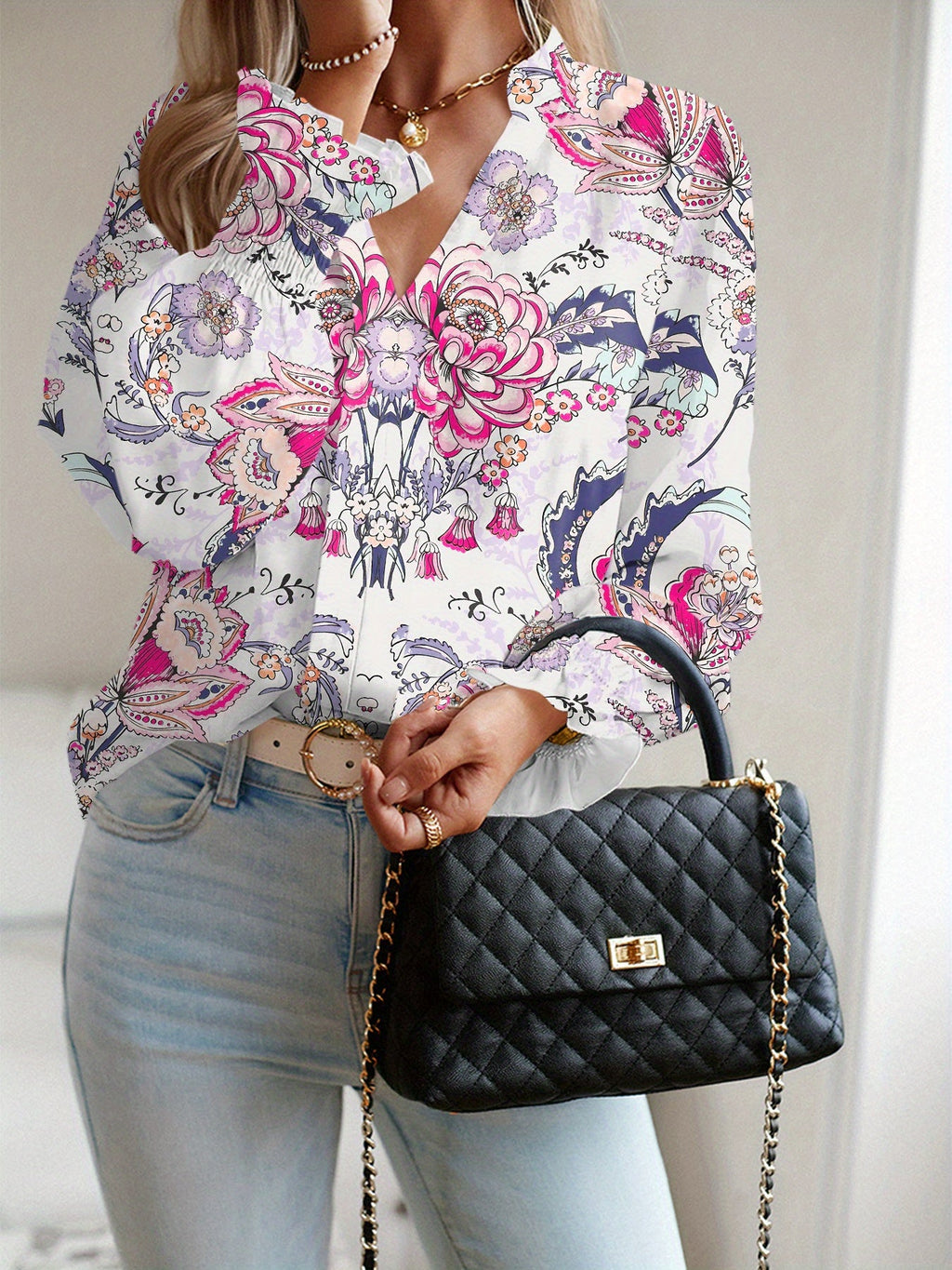 A loose, flower-patterned, long-sleeved, ruffled, elegant printed shirt